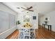 Bright dining room with a round table, white chairs, ceiling fan, and natural light at 13022 W Surrey Ave, El Mirage, AZ 85335