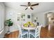 Cozy dining area featuring a round table, comfortable chairs, and a view into the kitchen at 13022 W Surrey Ave, El Mirage, AZ 85335