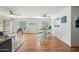 Open-concept living and dining area with hardwood floors, ceiling fans, and natural light at 13022 W Surrey Ave, El Mirage, AZ 85335