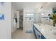 Main bathroom featuring a walk-in shower and large storage for towels at 13022 W Surrey Ave, El Mirage, AZ 85335