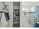 Main bathroom featuring a new walk-in shower with a shower niche for storage at 13022 W Surrey Ave, El Mirage, AZ 85335