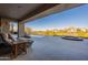 Back porch area with pool, lounge chairs, spa and beautiful views of the community and nearby mountain at 13412 N 14Th Pl, Phoenix, AZ 85022