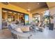 Covered outdoor seating area with ceiling fan and view to the interior living area at 13412 N 14Th Pl, Phoenix, AZ 85022