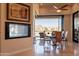 Dining area with glass top table, comfortable chairs, fireplace, and access to a large patio with scenic views at 13412 N 14Th Pl, Phoenix, AZ 85022