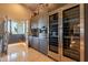 Contemporary kitchen with stainless steel wine cooler, built-in coffee maker, modern cabinets, and terrace access at 13412 N 14Th Pl, Phoenix, AZ 85022