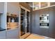 Modern kitchen featuring Miele appliances, built-in coffee maker, double wine cooler, and sleek gray cabinetry at 13412 N 14Th Pl, Phoenix, AZ 85022