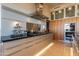 Modern kitchen featuring stainless steel appliances, a large island, and sleek cabinetry at 13412 N 14Th Pl, Phoenix, AZ 85022