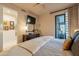 Comfortable main bedroom with a sliding glass door to the outside and a flat screen television at 13412 N 14Th Pl, Phoenix, AZ 85022