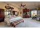 Large main bedroom with a king bed, sitting area, bookshelf, and natural light from the exterior windows at 13412 N 14Th Pl, Phoenix, AZ 85022