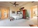 This spacious main bedroom has carpet, high ceilings, fan and is connected to the main bath and other rooms at 13412 N 14Th Pl, Phoenix, AZ 85022