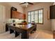 This home office has carpet, a ceiling fan, built-in cabinets, and large windows that provide natural light at 13412 N 14Th Pl, Phoenix, AZ 85022