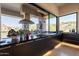 Well-equipped outdoor kitchen with a built-in grill, modern finishes, counterspace, and picturesque outdoor views at 13412 N 14Th Pl, Phoenix, AZ 85022
