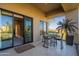 Outdoor patio area with a table and chairs, sliding glass doors, and scenic views of the surrounding landscape at 13412 N 14Th Pl, Phoenix, AZ 85022