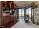 Sitting area featuring bookshelves with ladder, reading chair, and large windows providing scenic views at 13412 N 14Th Pl, Phoenix, AZ 85022