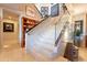 Staircase with glass railing and artfully decorated walls leads up to the second floor of the home at 13412 N 14Th Pl, Phoenix, AZ 85022