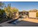 Custom water feature surrounded by desert landscaping adds a tranquil element to the outdoor space at 13412 N 14Th Pl, Phoenix, AZ 85022
