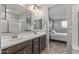 Elegant bathroom with double sinks and a view into the bedroom at 13648 W Desert Glen Dr, Sun City West, AZ 85375