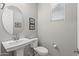 Clean, modern powder room with pedestal sink and toilet at 13648 W Desert Glen Dr, Sun City West, AZ 85375