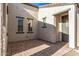 Brick paved patio with a gray front door and side windows at 13648 W Desert Glen Dr, Sun City West, AZ 85375