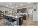 Modern kitchen with island, stainless steel appliances, and dark cabinets at 13648 W Desert Glen Dr, Sun City West, AZ 85375