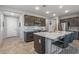 Modern kitchen with island, stainless steel appliances, and dark cabinets at 13648 W Desert Glen Dr, Sun City West, AZ 85375