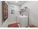 Convenient laundry room with washer, dryer, and shelving at 13648 W Desert Glen Dr, Sun City West, AZ 85375