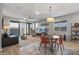 Living room with a ceiling fan, large TV, and sliding door to patio at 13648 W Desert Glen Dr, Sun City West, AZ 85375