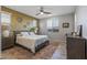 Spacious primary bedroom with neutral tones, ample natural light and ensuite bathroom at 13648 W Desert Glen Dr, Sun City West, AZ 85375