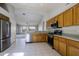 Open kitchen featuring stainless steel appliances and light wood cabinets at 14790 W Merrell St, Goodyear, AZ 85395