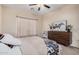 Charming bedroom with a king-size bed and a dresser at 14836 W Desert Hills Dr, Surprise, AZ 85379