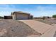 Attached two-car garage with a long driveway at 15442 S Tipton Pl, Arizona City, AZ 85123