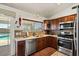 Modern kitchen featuring stainless steel appliances and wood cabinetry at 15442 S Tipton Pl, Arizona City, AZ 85123