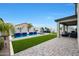 Lush backyard featuring a refreshing pool, spa, and comfortable seating area at 17706 W Villa Chula Ln, Surprise, AZ 85387