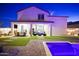 A spacious backyard offers an enjoyable outdoor living space with a covered patio and sparkling pool at 17706 W Villa Chula Ln, Surprise, AZ 85387