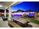 A covered patio extends to a pool, hot tub, and outdoor dining area in the backyard at 17706 W Villa Chula Ln, Surprise, AZ 85387