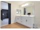 Bright and airy bathroom featuring a double vanity and dark blue accent wall at 17706 W Villa Chula Ln, Surprise, AZ 85387