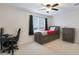 A cozy bedroom with a unique platform bed, a functional workspace, and ample natural light for a comfortable living space at 17706 W Villa Chula Ln, Surprise, AZ 85387