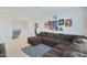 A cozy bonus room featuring a large sectional sofa, complemented by colorful artwork and a welcoming atmosphere at 17706 W Villa Chula Ln, Surprise, AZ 85387