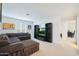 A bright bonus room with a comfortable sectional sofa, modern media setup, and an open layout, ideal for flexible living at 17706 W Villa Chula Ln, Surprise, AZ 85387
