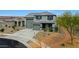 Well-maintained two-story home with a three-car garage and mature desert landscaping at 17706 W Villa Chula Ln, Surprise, AZ 85387