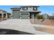Two-story home featuring a three-car garage, desert landscaping, and a neutral color scheme at 17706 W Villa Chula Ln, Surprise, AZ 85387