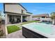 A beautifully landscaped backyard featuring a luxurious hot tub and a refreshing swimming pool for the ultimate outdoor enjoyment at 17706 W Villa Chula Ln, Surprise, AZ 85387
