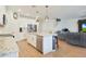 Modern kitchen with granite countertops, stainless steel appliances, and an island with seating at 17706 W Villa Chula Ln, Surprise, AZ 85387