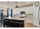 Bright kitchen featuring a large island with seating and granite countertops, plus stainless steel appliances at 17706 W Villa Chula Ln, Surprise, AZ 85387