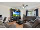 Comfortable living area with a sectional sofa, media center, and a bright, airy feel at 17706 W Villa Chula Ln, Surprise, AZ 85387