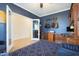 Another view of office features hardwood floors, blue accent wall, and french doors at 17706 W Villa Chula Ln, Surprise, AZ 85387