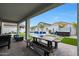 Covered patio featuring outdoor seating, with a view of the backyard pool and spa at 17706 W Villa Chula Ln, Surprise, AZ 85387
