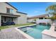 A backyard featuring a sparkling swimming pool with a blue-tile border and a neatly designed patio with comfortable outdoor seating at 17706 W Villa Chula Ln, Surprise, AZ 85387
