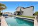 A stunning backyard with a private pool, complemented by an outdoor dining and lounge area, set against a beautiful home exterior at 17706 W Villa Chula Ln, Surprise, AZ 85387