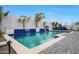 Beautiful pool featuring waterfall features and surrounded by artificial turf and stone pavers at 17706 W Villa Chula Ln, Surprise, AZ 85387